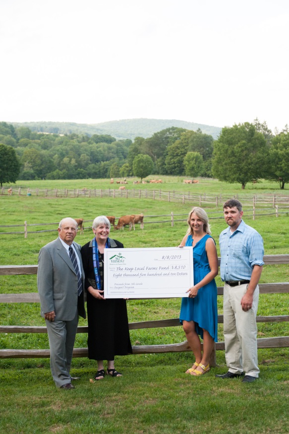 Dairy farmers accept a check for $8,510 from Sarah Neith of Ski Vermont to benefit the Keep Local Farms Fund, which supports the long-term viability of New England’s dairy farms. (From left to right: Tim Bryant, dairy farmer from Pawlet, VT and Chairman of New England Dairy Promotion Board; Beth Kennett, dairy farmer and owner of Liberty Hill Farm Inn, Rochester, VT; Sarah Neith of Ski Vermont; David Kennett of Liberty Hill Farm Inn, Rochester, VT.)