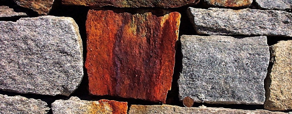 rust stained rocks in wall